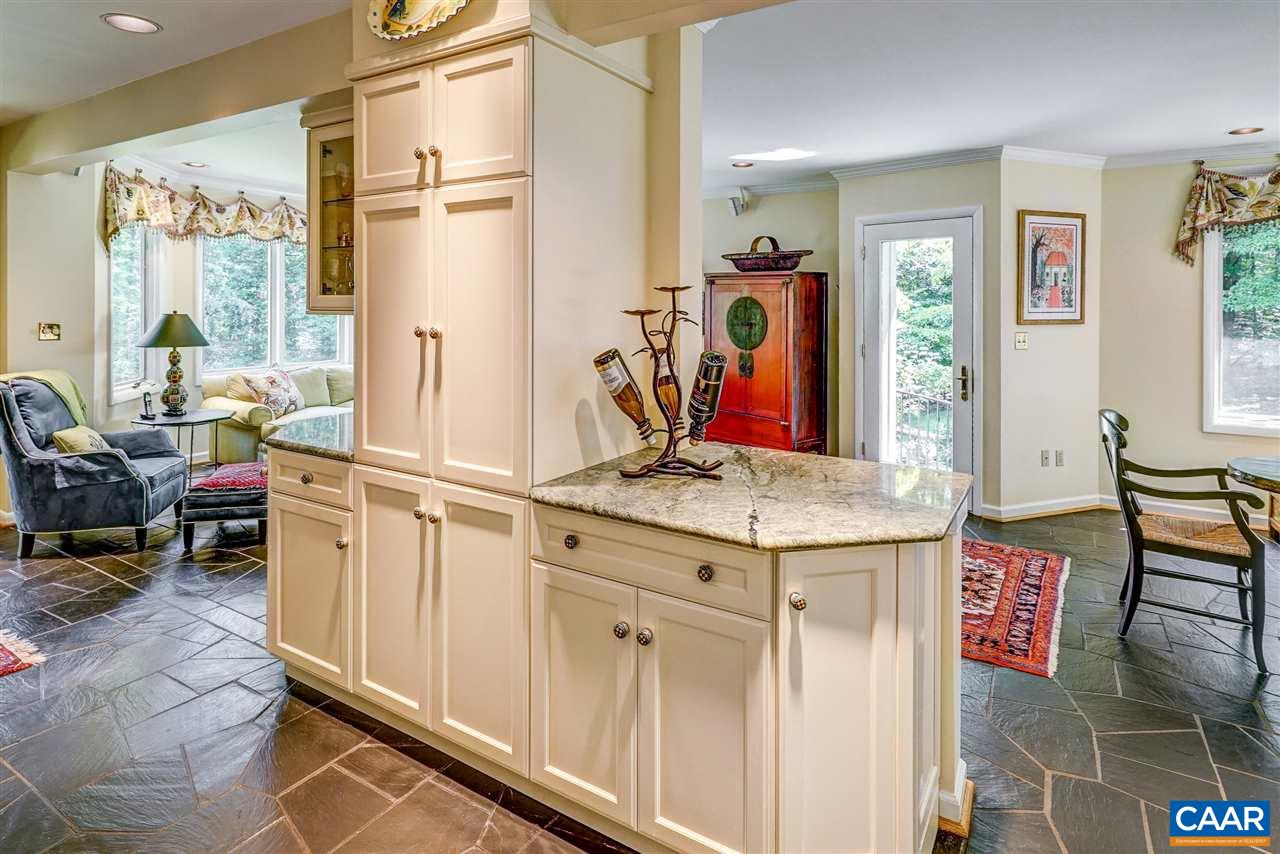 1075 Richmond Road Keswick, VA 22947 - Photo 21 of 50 a hall with kitchen island granite countertop wooden cabinets and a counter top space