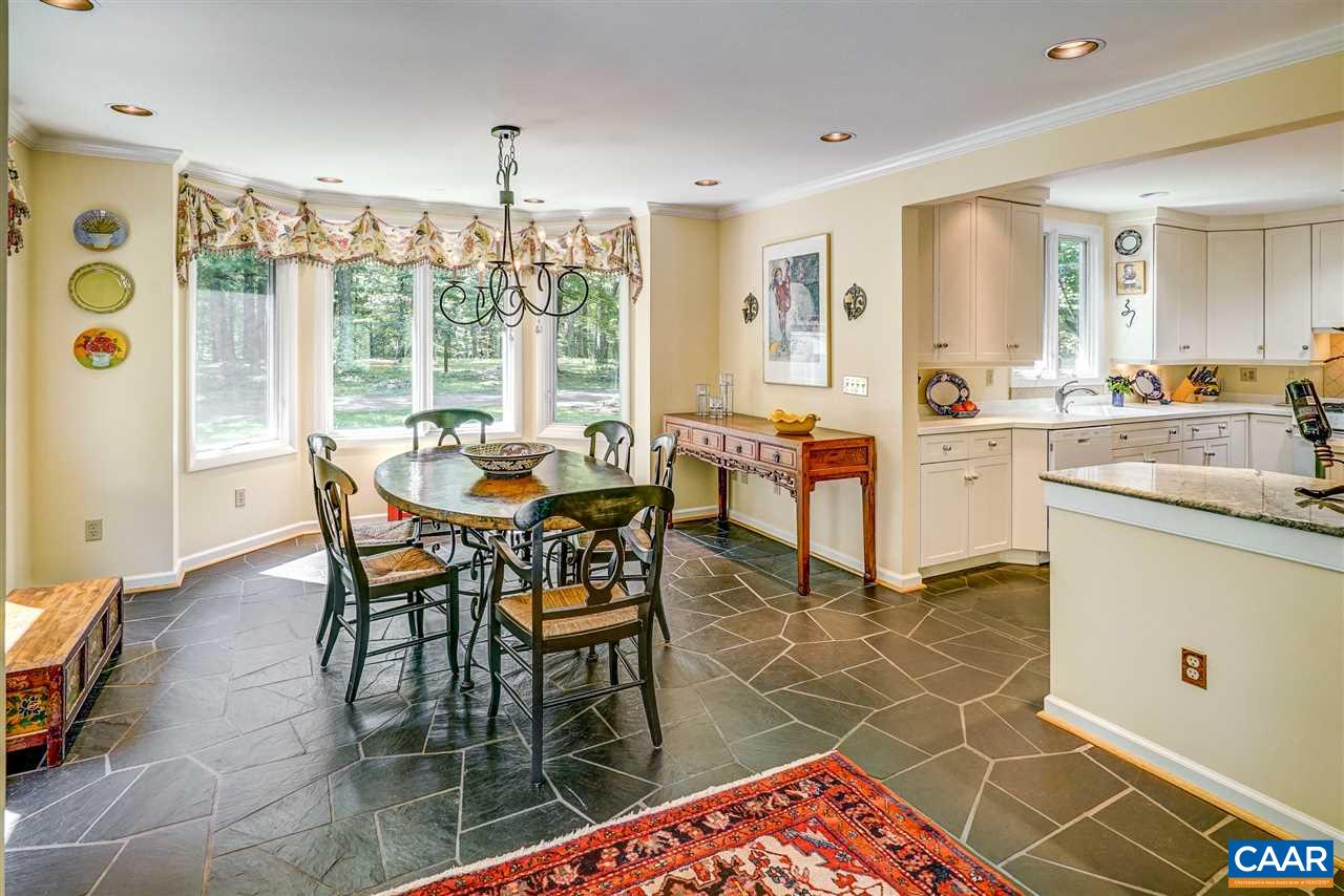 1075 Richmond Road Keswick, VA 22947 - Photo 28 of 50 a dining hall with stainless steel appliances a dining table and chairs with the wooden floor