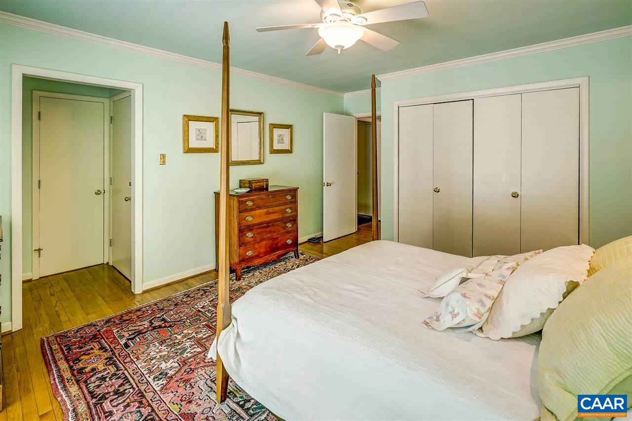 1075 Richmond Road Keswick, VA 22947 - Photo 31 of 50 a bedroom with a bed and a chandelier