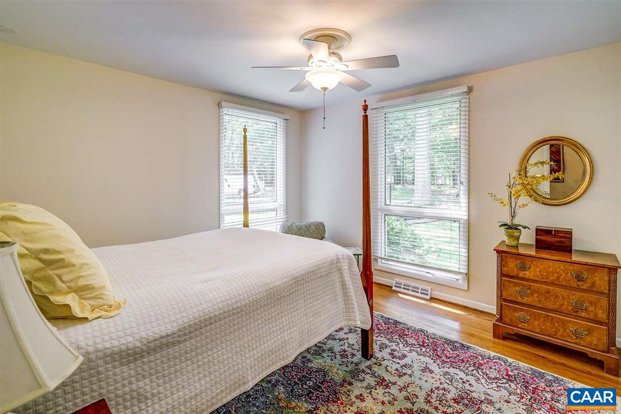 1075 Richmond Road Keswick, VA 22947 - Photo 33 of 50 a bedroom with a bed and a chandelier