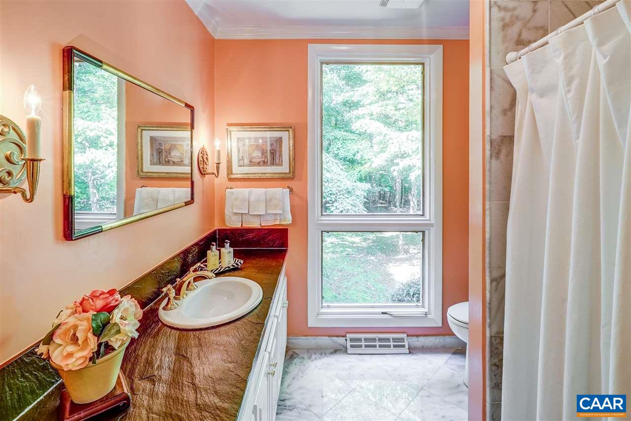 1075 Richmond Road Keswick, VA 22947 - Photo 35 of 50 a bathroom with a sink toilet and a mirror