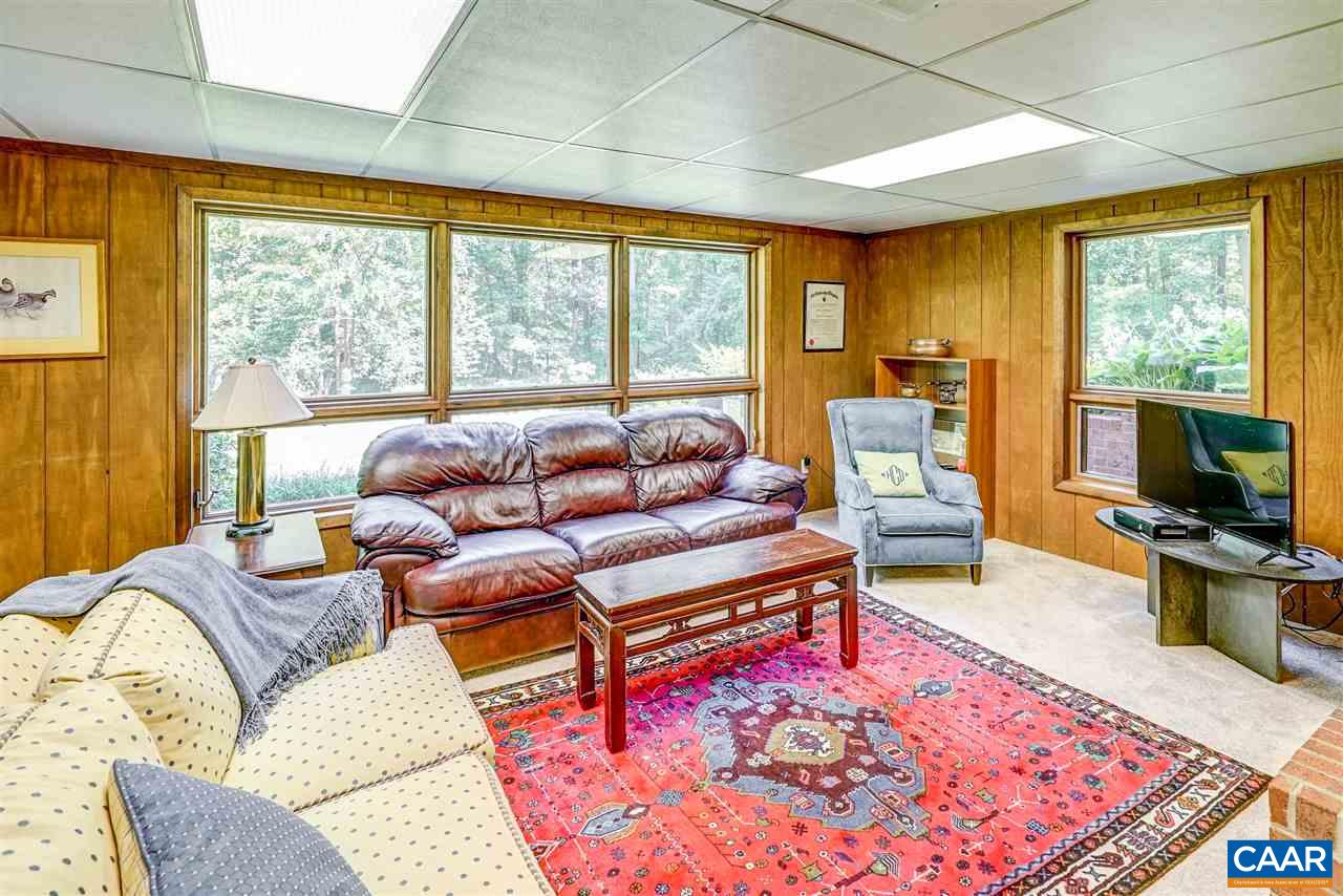1075 Richmond Road Keswick, VA 22947 - Photo 36 of 50 a living room with furniture a rug and a flat screen tv
