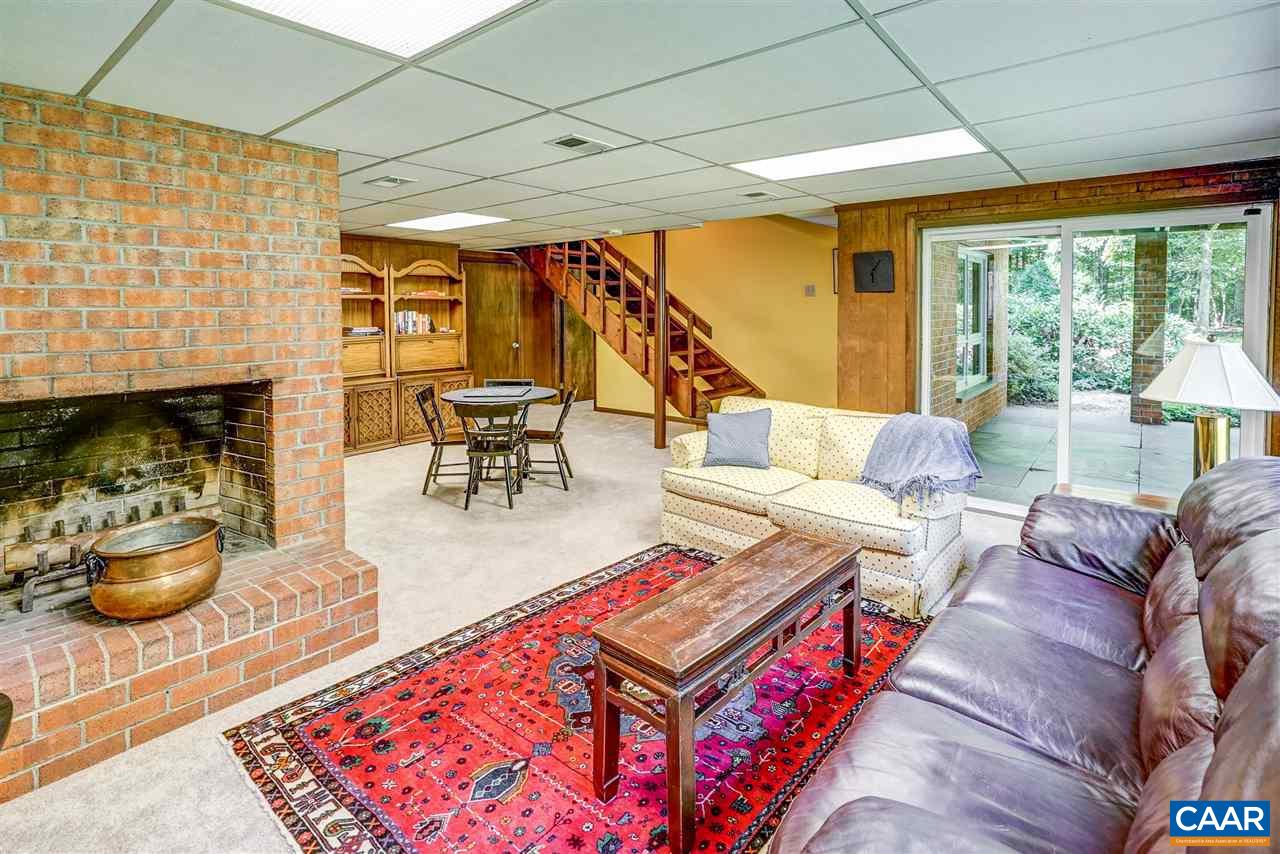 1075 Richmond Road Keswick, VA 22947 - Photo 38 of 50 a living room with furniture a fireplace and a table