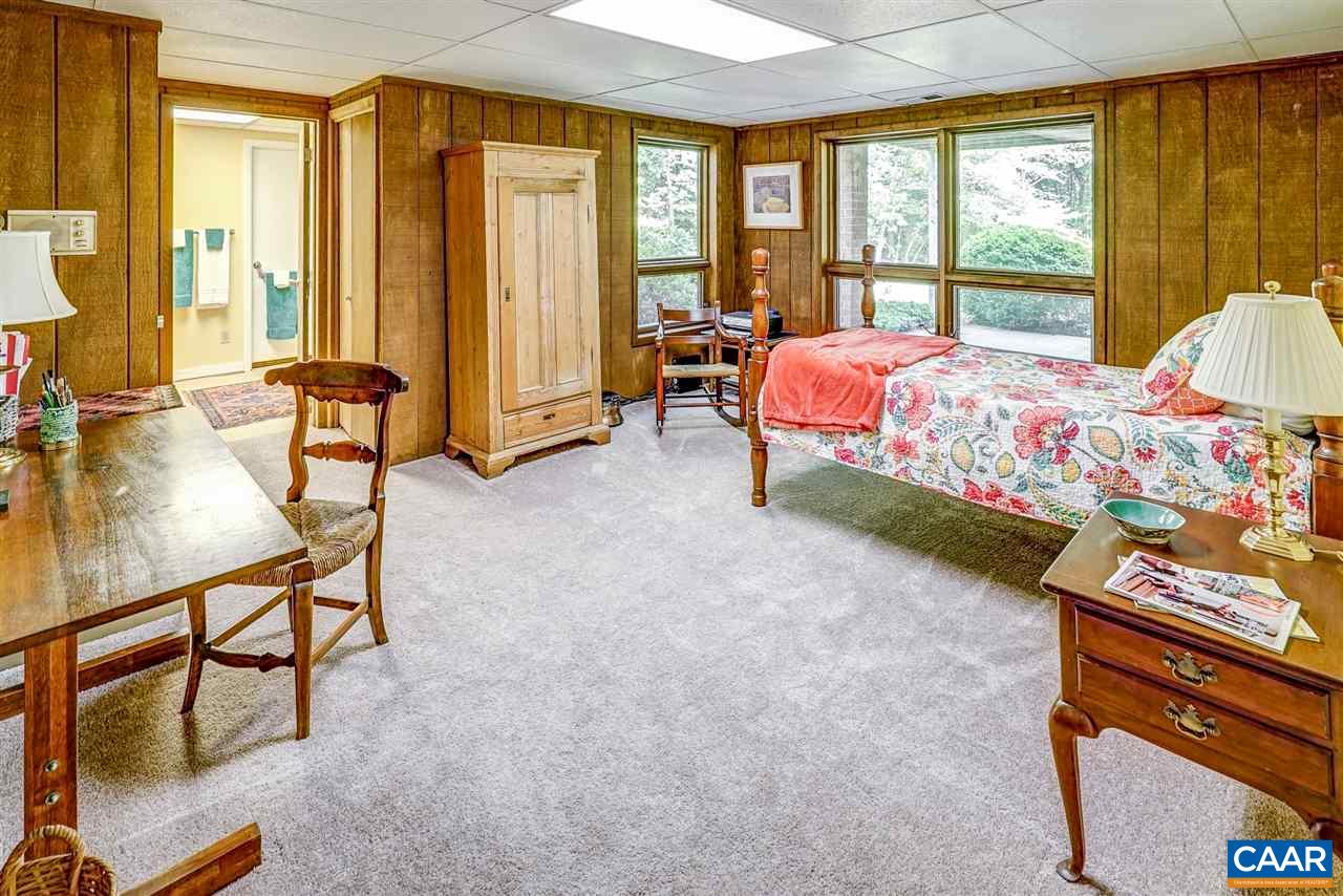 1075 Richmond Road Keswick, VA 22947 - Photo 40 of 50 a bedroom with a bed and large windows