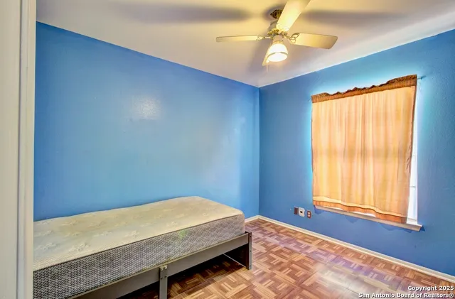 a bedroom with a bed dresser and a window