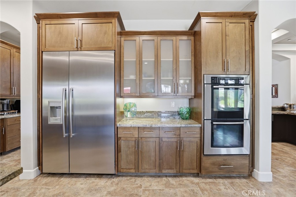 14779 Wood Riverside, CA 92508 - Photo 17 of 70 a kitchen with granite countertop a refrigerator and a stove