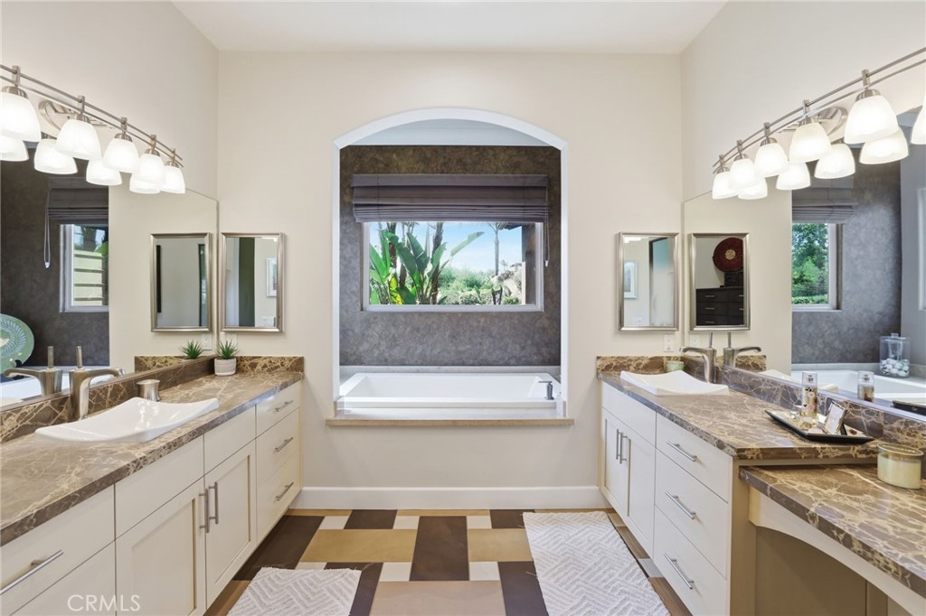 14779 Wood Riverside, CA 92508 - Photo 32 of 70 a bathroom with a granite countertop sink mirror and a bathtub