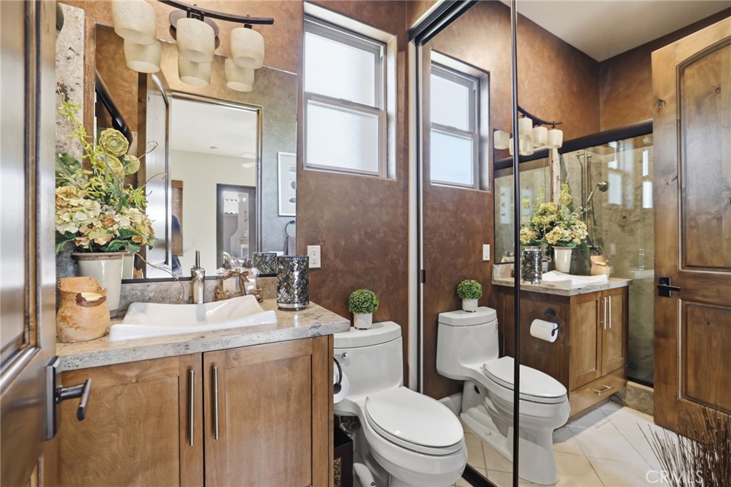14779 Wood Riverside, CA 92508 - Photo 39 of 70 a bathroom with a sink a toilet a mirror and shower