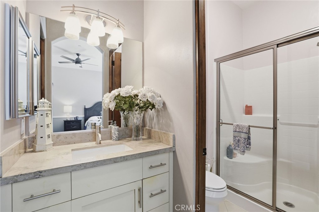 14779 Wood Riverside, CA 92508 - Photo 41 of 70 a bathroom with a granite countertop shower sink and mirror