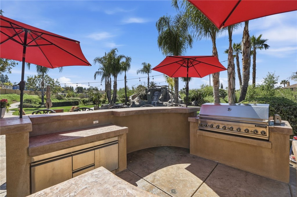 14779 Wood Riverside, CA 92508 - Photo 48 of 70 a view of a patio with a table and chairs under an umbrella