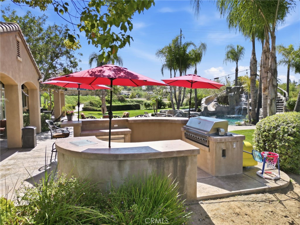 14779 Wood Riverside, CA 92508 - Photo 49 of 70 a view of a patio with a table and chairs under an umbrella