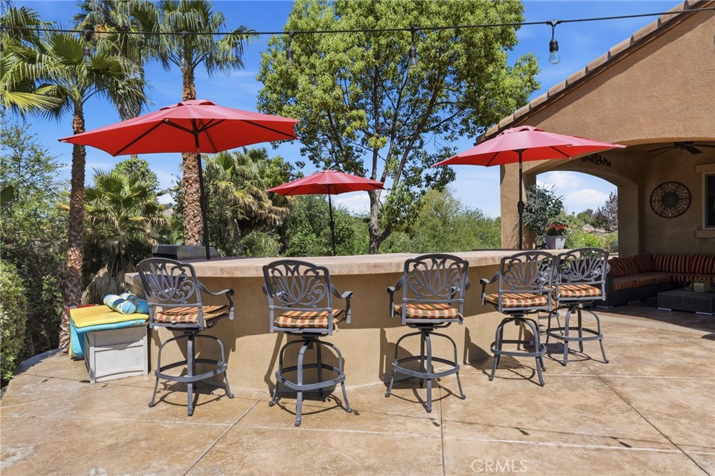 14779 Wood Riverside, CA 92508 - Photo 50 of 70 a view of a patio with a table and chairs under an umbrella