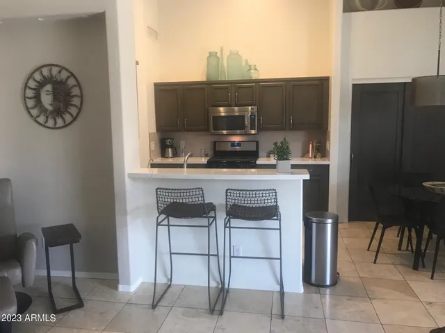 a kitchen with a table and chairs