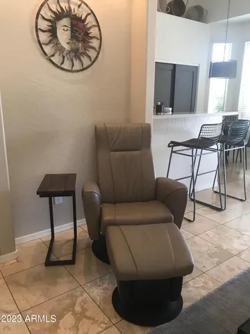 a living room with furniture a flat screen tv and a table