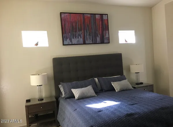 a bed sitting in a bedroom next to a window
