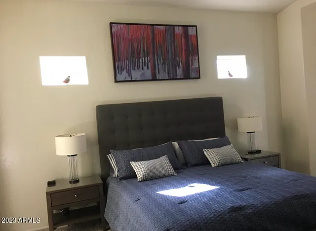 a bed sitting in a bedroom next to a window