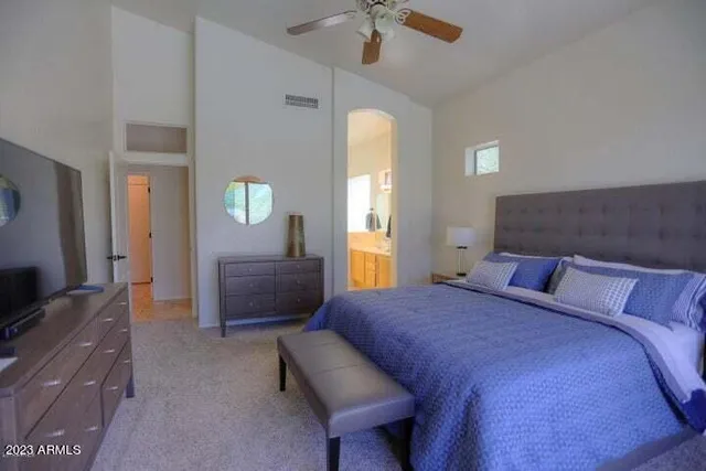 a bedroom with a bed and a couch