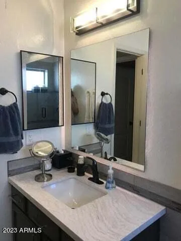 a room with a sink and a mirror