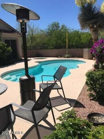 a view of table and chairs under an umbrella
