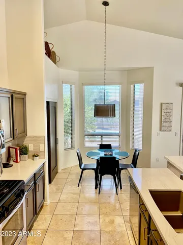 a open kitchen with stainless steel appliances kitchen island granite countertop a sink a stove and a wooden floors