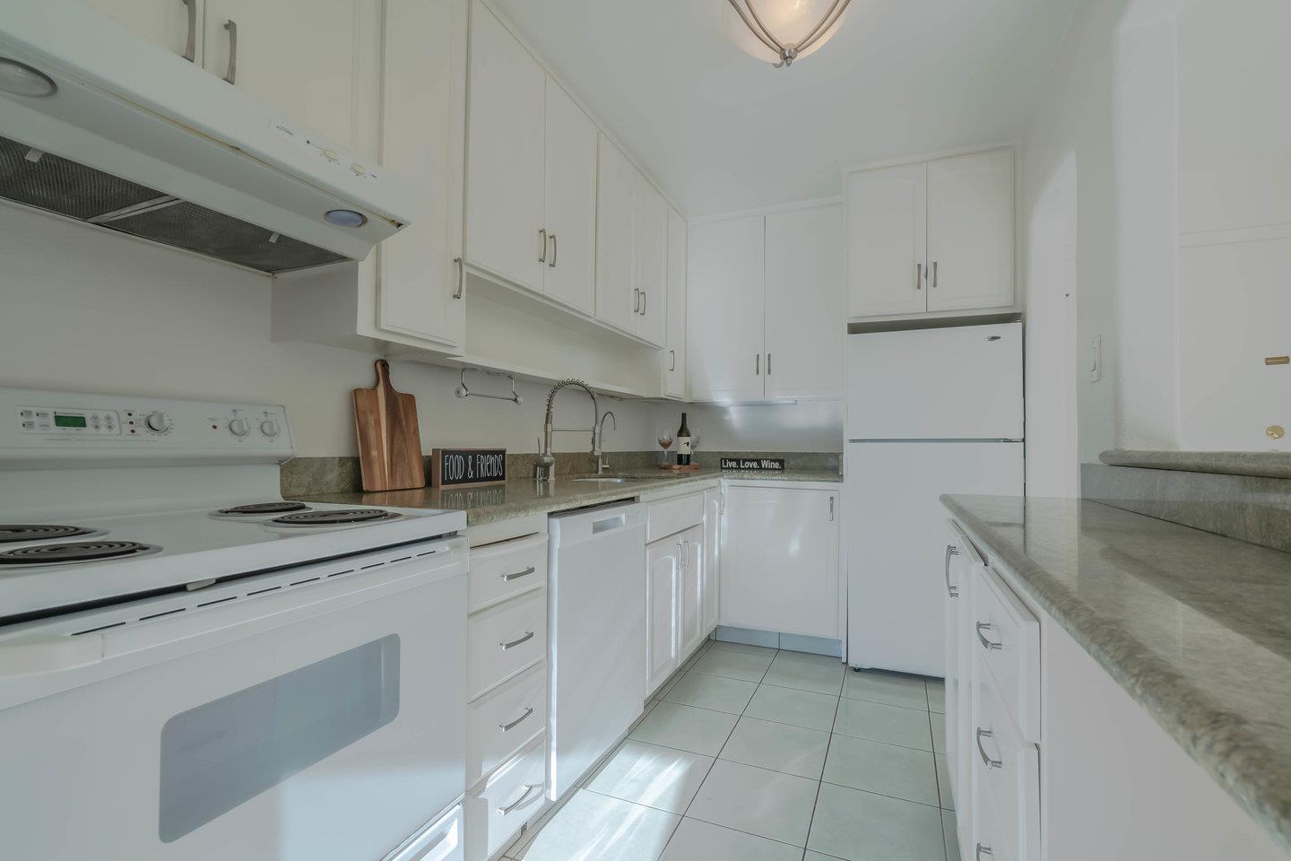 818 North Delaware Street, Unit 314 San Mateo, CA 94401 - Photo 4 of 18 a kitchen with granite countertop white cabinets and white appliances