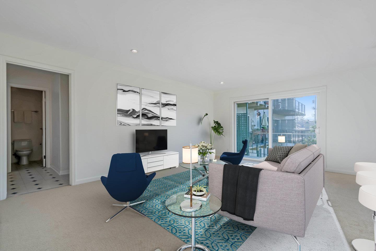 818 North Delaware Street, Unit 314 San Mateo, CA 94401 - Photo 6 of 18 a living room with furniture a rug and a chandelier