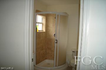 8164 Matanzas Road Fort Myers, FL 33967 - Photo 8 of 9 a bathroom with a glass shower door