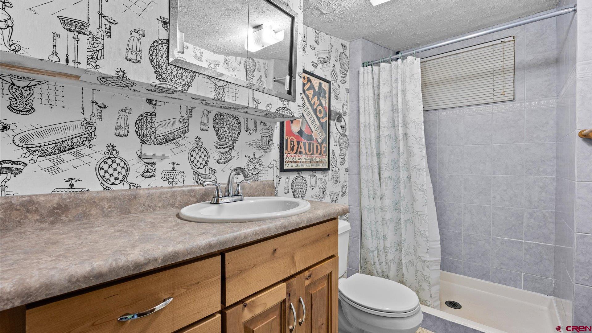 1424 Dover Road Montrose, CO 81401 - Photo 21 of 44 a bathroom with a granite countertop sink a toilet and shower