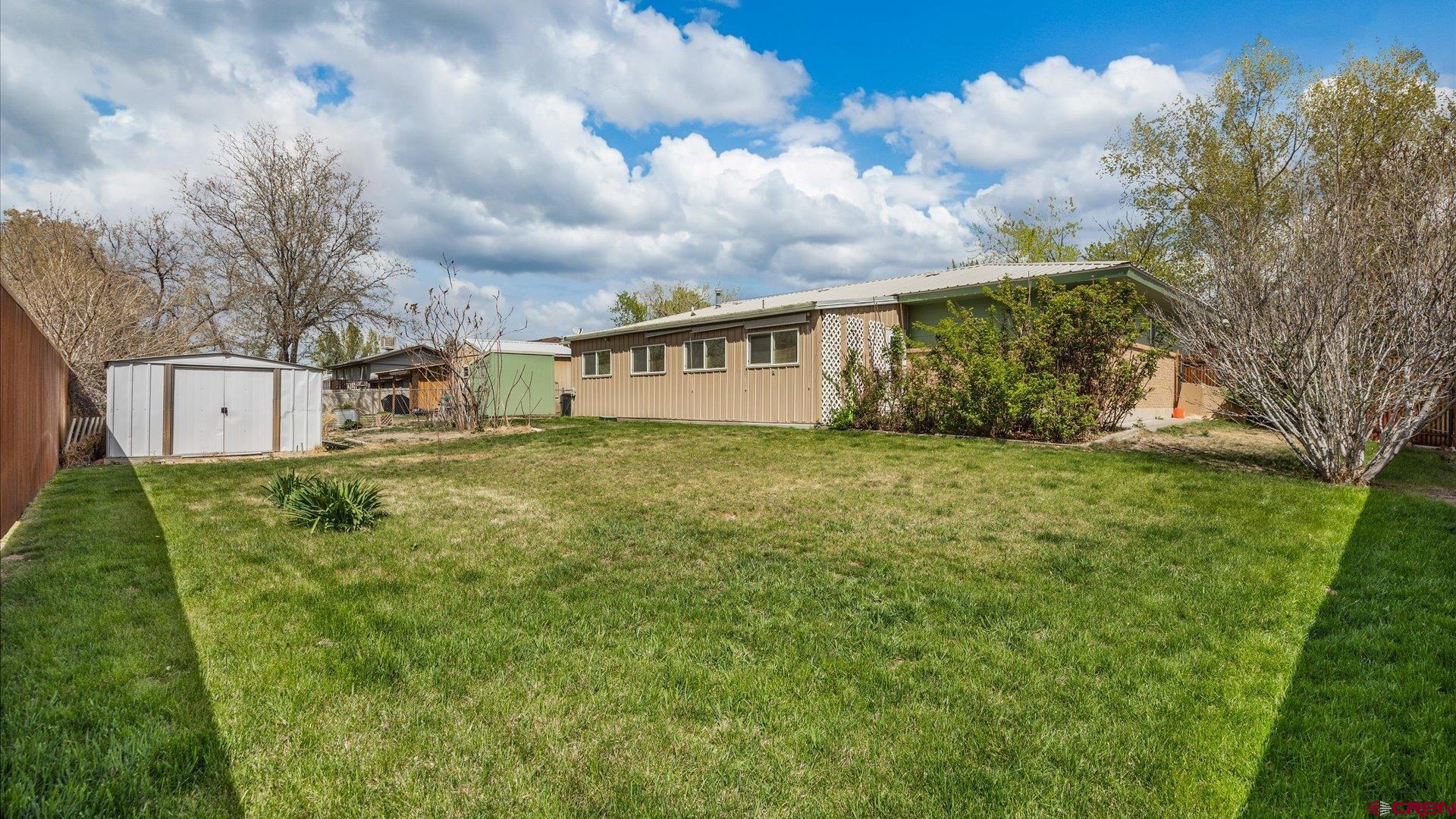 1424 Dover Road Montrose, CO 81401 - Photo 42 of 44 a view of a house with a big yard and a large tree
