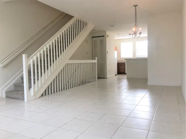 a view of a hallway with windows and entryway