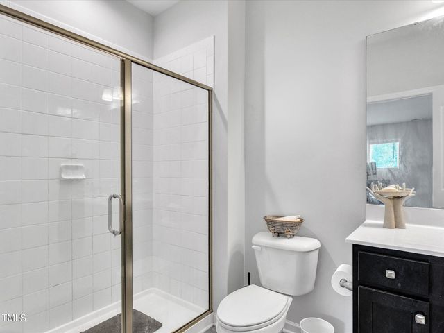 a bathroom with a toilet a sink and shower