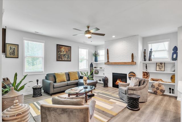 a living room with furniture fireplace and a window