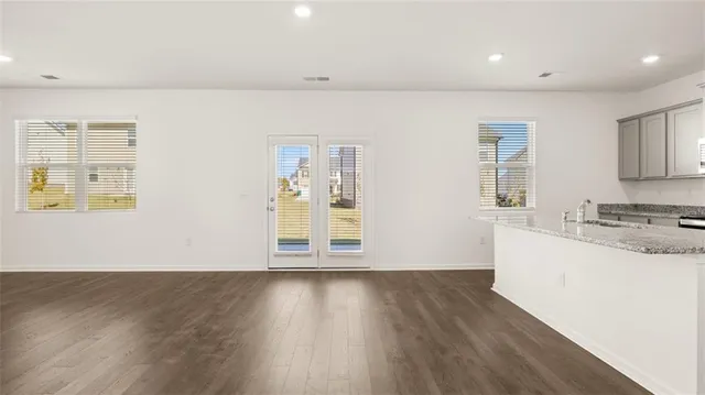 a view of a kitchen with wooden floor and a sink