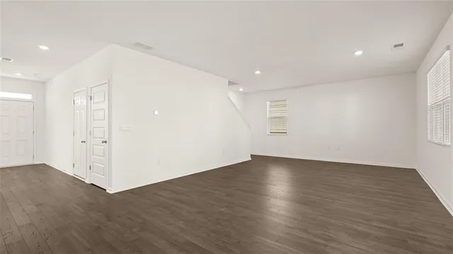 an empty room with wooden floor