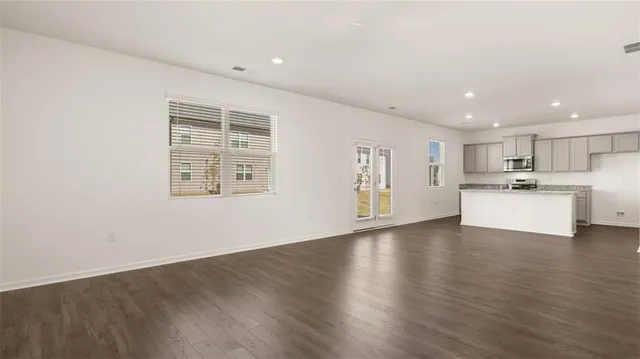 a view of a kitchen with a sink dishwasher stove top oven and refrigerator