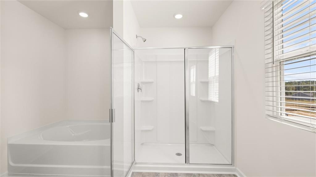 69 White Spruce Way Newnan, GA 30265 - Photo 25 of 40 a bathroom with a glass shower door