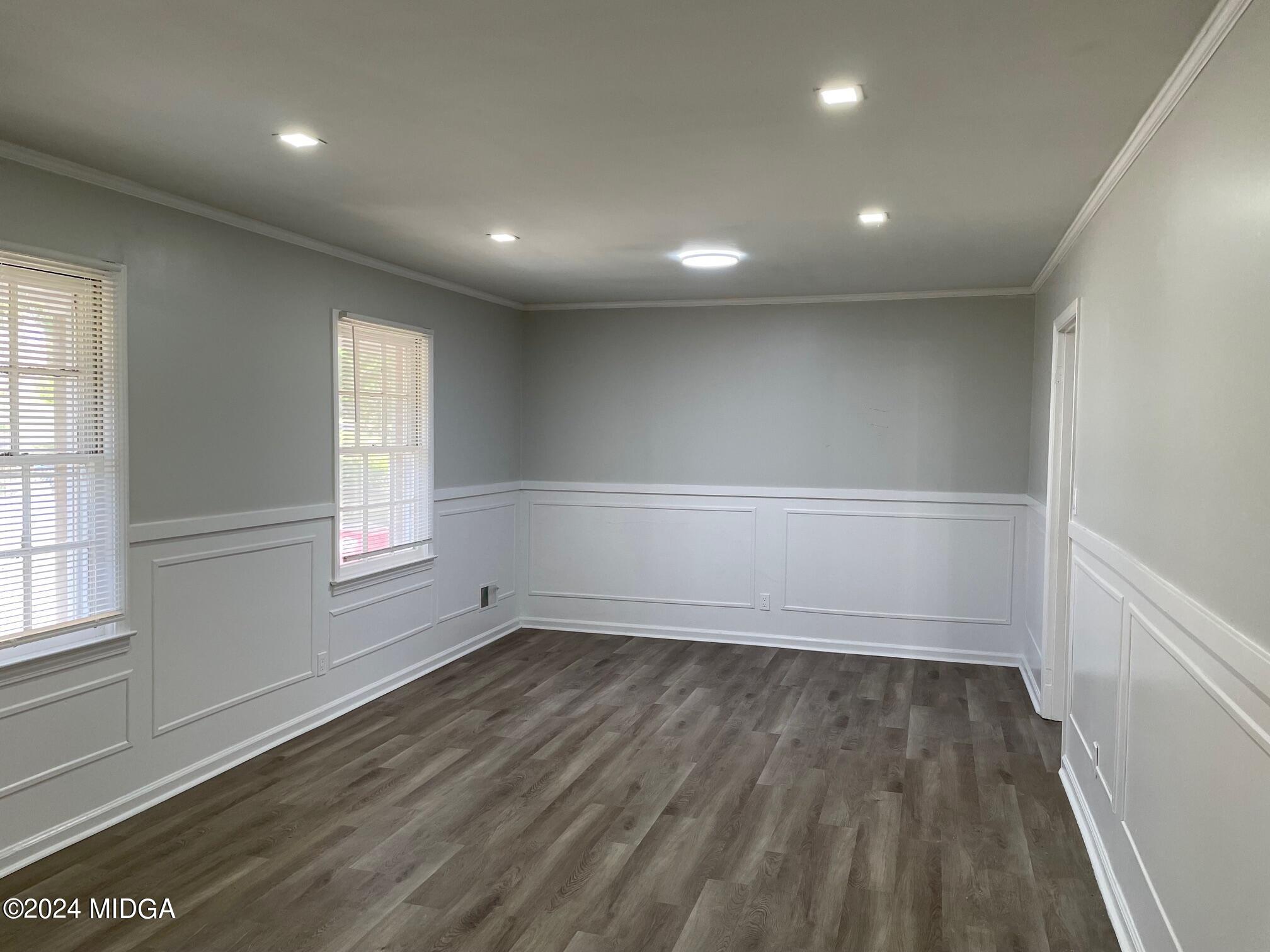 2069 Manson Road Macon, GA 31217 - Photo 3 of 15 an empty room with wooden floor and windows