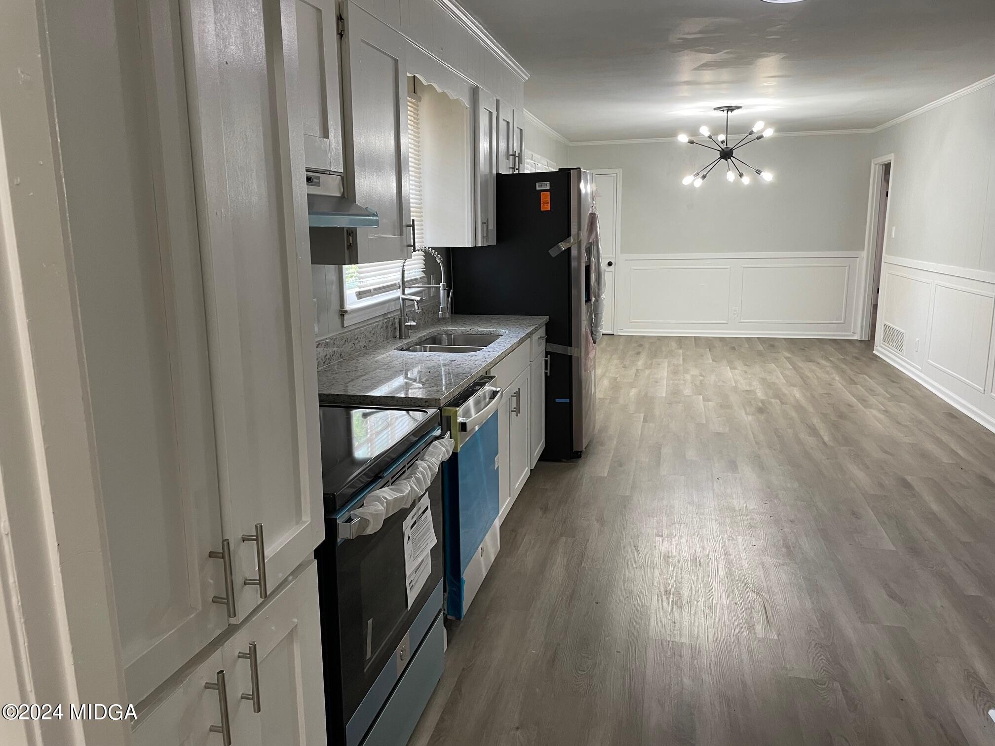 2069 Manson Road Macon, GA 31217 - Photo 6 of 15 a kitchen with granite countertop a refrigerator and a stove top oven