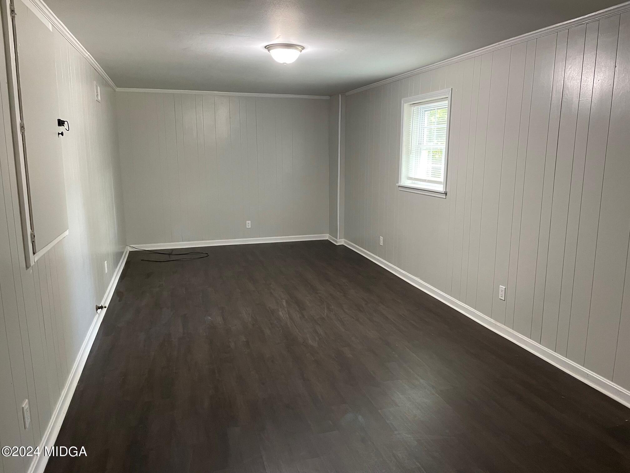 2069 Manson Road Macon, GA 31217 - Photo 7 of 15 an empty room with wooden floor and windows