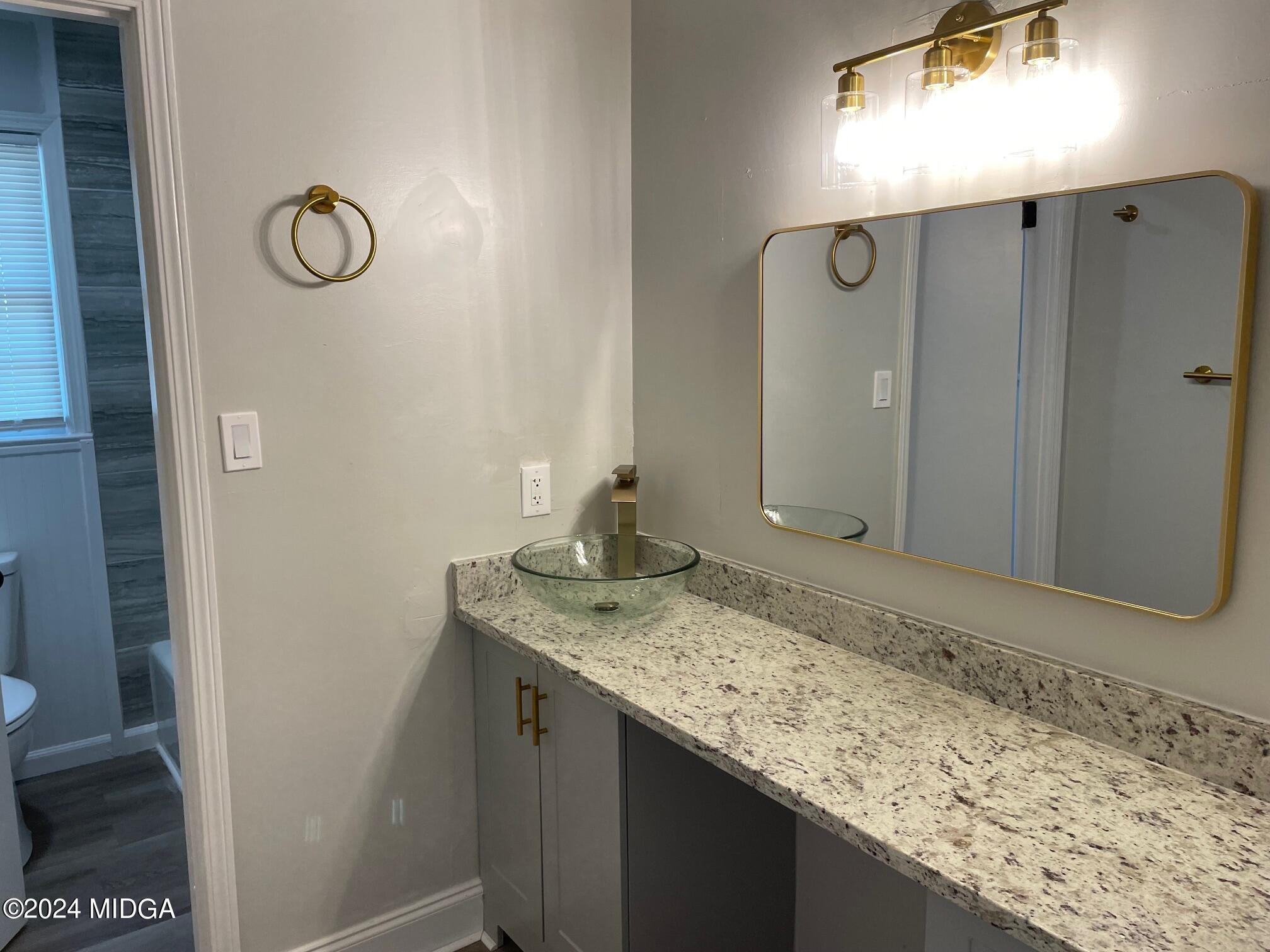 2069 Manson Road Macon, GA 31217 - Photo 10 of 15 a bathroom with a granite countertop sink and a mirror