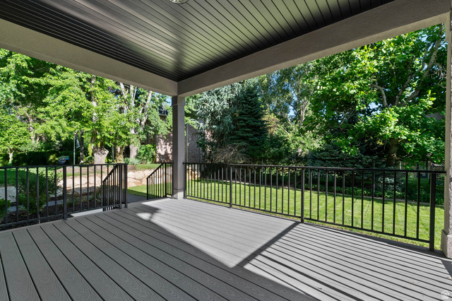 2724 Mt Jordan Road Sandy, UT 84092 - Photo 35 of 39 Spacious covered deck featuring composite decking, black metal railings, and an overhead light fixture