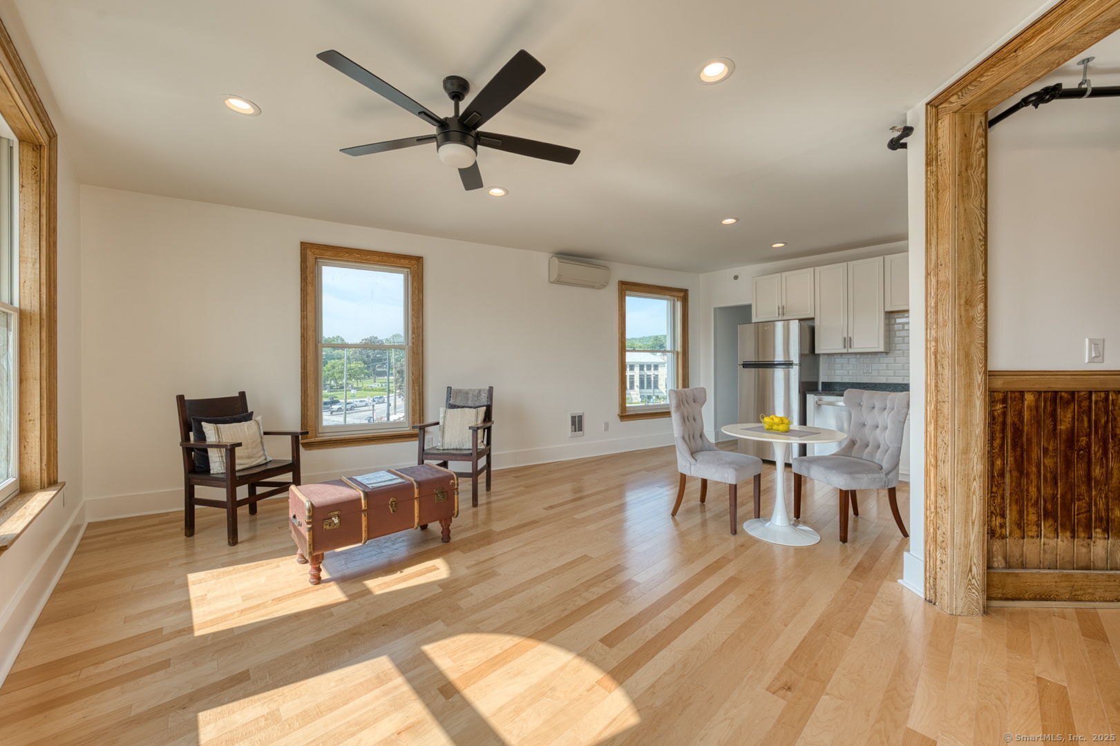 11 Main Street, Unit 301 Torrington, CT 06790 - Photo 2 of 14 a living room with furniture kitchen view and a wooden floor