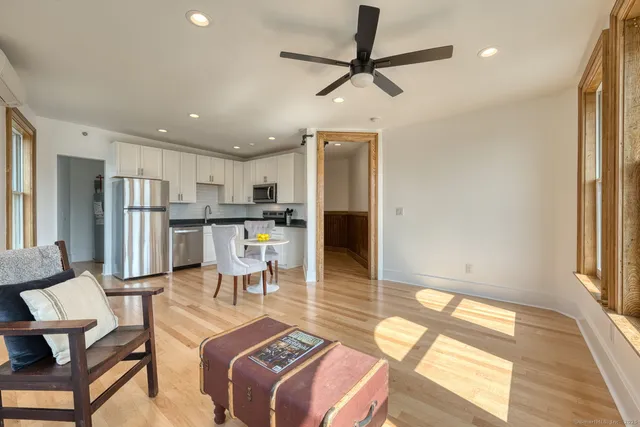 a living room with stainless steel appliances kitchen island granite countertop furniture and a kitchen view