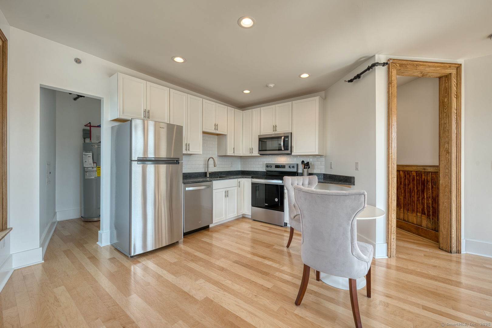 11 Main Street, Unit 301 Torrington, CT 06790 - Photo 4 of 14 a kitchen with stainless steel appliances a refrigerator stove microwave and cabinets