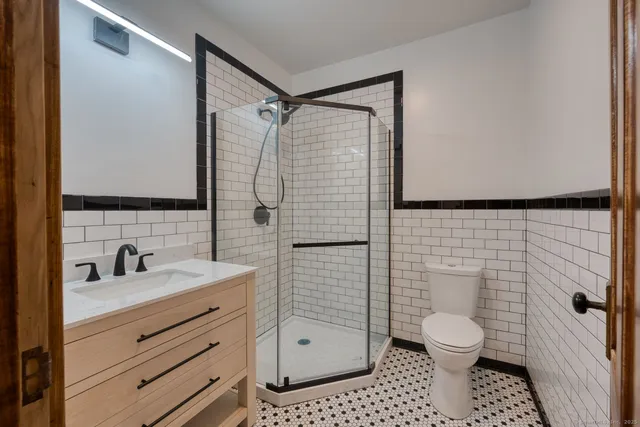a bathroom with a toilet sink and shower