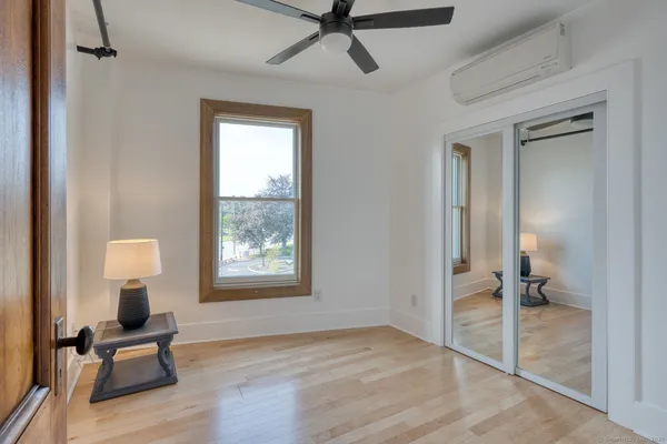 a view of a livingroom with a chair and wooden floor