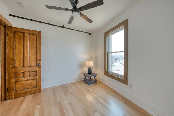 a view of a room with wooden floor cabinet and windows