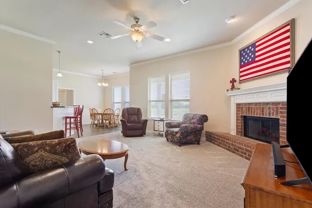 a living room with furniture fireplace and a window