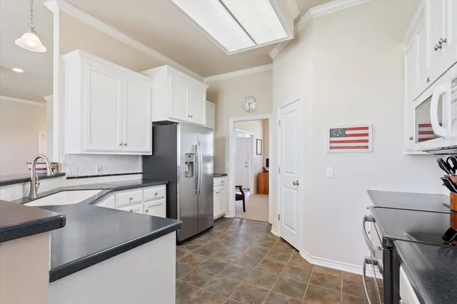 a kitchen that has a refrigerator and a sink