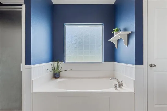 a bathroom with a sink a vanity and a bathtub